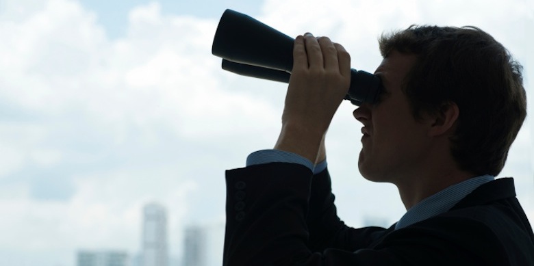 man looking through binoculars