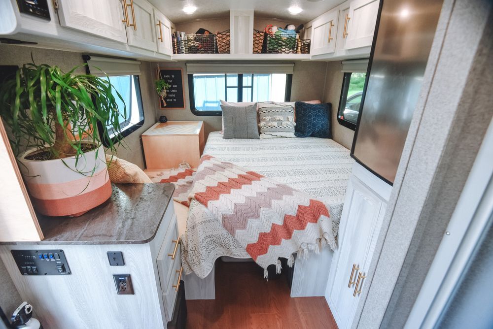 bed and shelves inside an organized tiny house