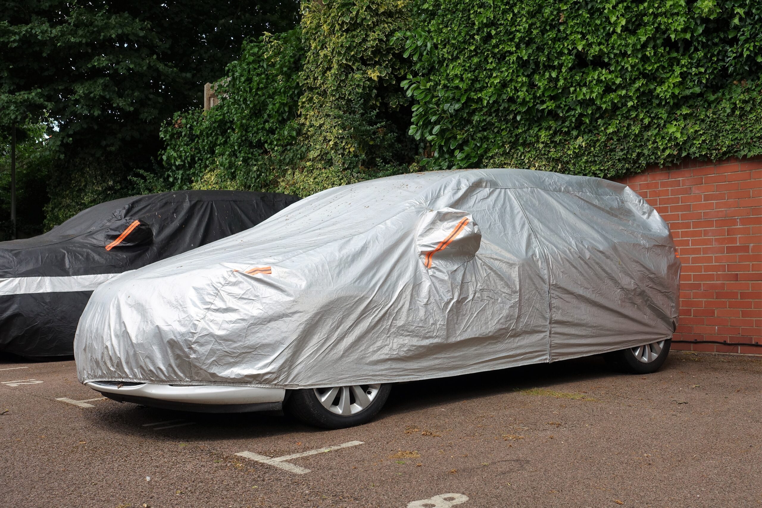 A car under protective cover in parking space