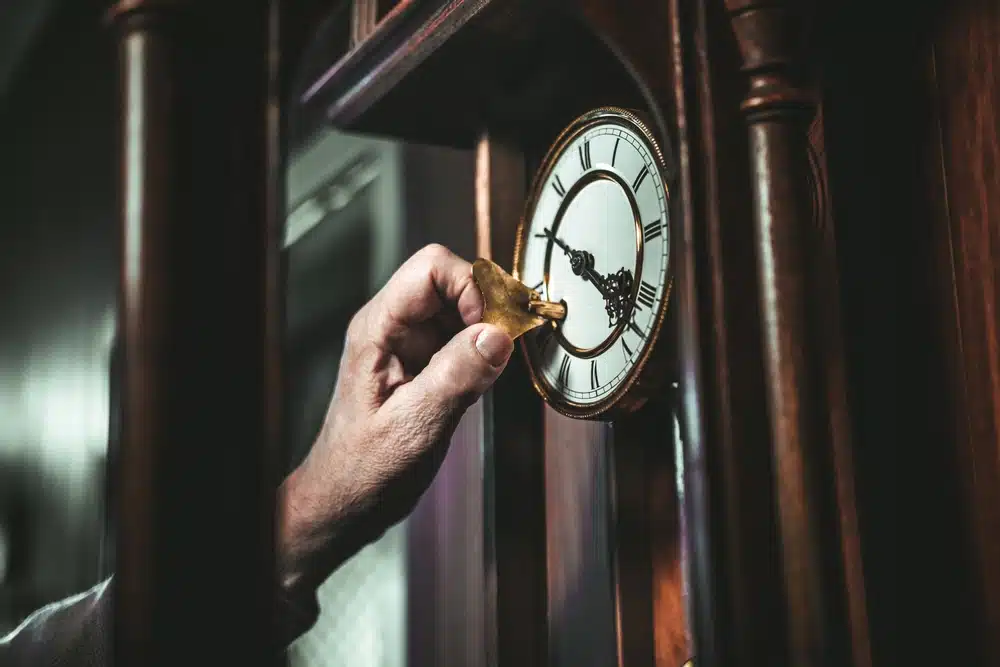 adjusting a grandfather clock